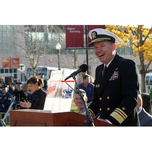 Vice Admiral Mark Fitzgerald laughs at the podium at the Veterans Memorial dedication ceremony