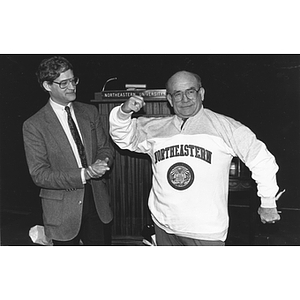 Ed Asner poses with his new Northeastern sweatshirt