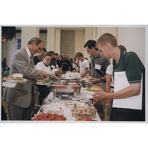 Daniel Givelber and other attendees filling plates at the School of Law orientation, 1998