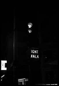 Traffic light at night with Don't walk illuminated, corner of Raleigh and Beacon Streets