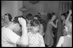 Teenage long hair: boys combing their hair while dancing with girls
