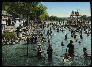 Crowded swimming area at a lake
