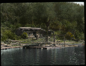 Camp- Lake Vassal P.Q. (log cabin and raft by a lake)