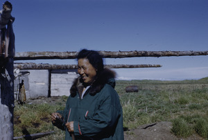 Woman posing outside her home