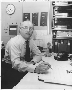 Edwin Lasalle sitting indoors, working at desk