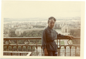 Shirley Graham Du Bois standing on a balcony, the city in the background