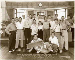 The Harlem Globetrotters at the La Perla Cigar and Cigarette Factory in Paranaque, Philippines on September 3, 1952.