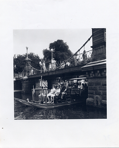 Swan boat passing under the Boston Public Garden Foot Bridge