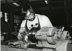 Unidentified man in glasses operating machinery