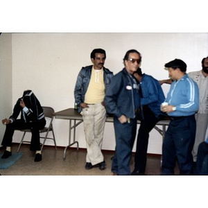 Unidentified male Inquilinos Boricuas en Acción employees at a staff party.
