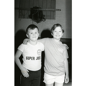 Two boys stand in front of a net at the South Boston gymnasium