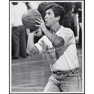 TV personality Tom Bergeron preparing to shoot a basketball at a fund-raising event held by the Boys and Girls Clubs of Boston and Boston Celtics