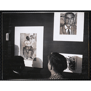 South Boston Boys' Club member Blaine Campbell, at right, views the Boys' Clubs of Boston Tri-Club Art Exhibit at the Museum of Science