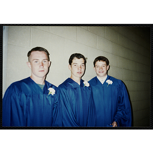 Three teenage boys pose for a shot during an Edwards School graduation ceremony