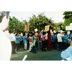 Protesters and a speaker at a demonstration for workers' rights
