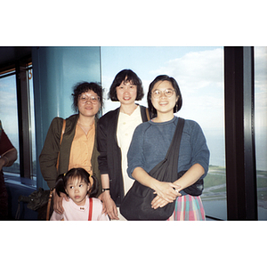 Lydia Lowe stands near a window with two other women and a girl