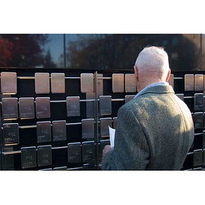 A man looks at the plaques on the Veterans Memorial at the dedication ceremony