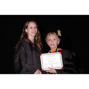 Dean Carole Kenner presents Danielle Beaumont with an Academic Promise Award at the School of Nursing convocation ceremony