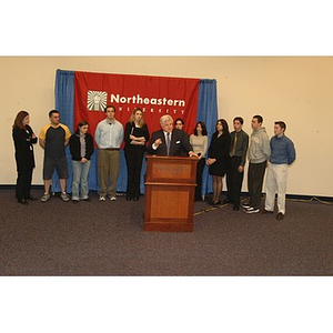 U.S. Senator Edward Kennedy (D-MA) speaks at the podium surrounded by students during a press conference on student aid