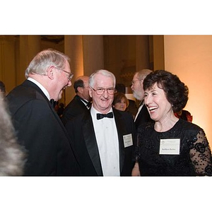 Neal Finnegan laughs with two guests at the Museum of Fine Arts