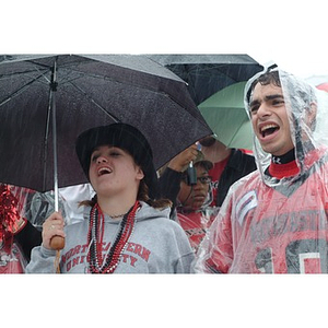 Heidi Buchanan, the Mayor of Huntington Avenue, cheers on the team from beneath her umbrella