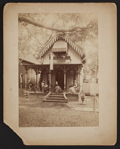 Exterior view of a house with four people sitting on the porch, Oak Bluffs, Martha's Vineyard, Mass., undated