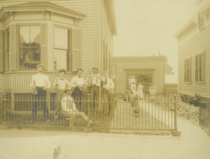 Full-length group portrait of tennis players, standing, facing front, in the front yard of William Bickerton, florist, 27 Gardner Street, Salem, Mass., undated