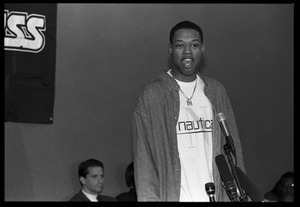 Marcus Camby standing at the microphone during a press conference