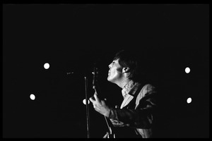 John Lennon (the Beatles) playing guitar and singing in concert at D.C. Stadium