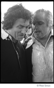 Bill Graham (left) talking to Marlon Brando