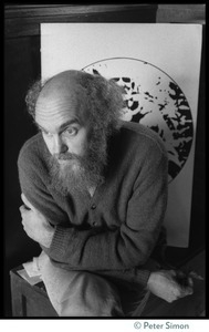 Ram Dass seated in front of a print of Neem Karoli Baba at the house at 181 Vicente Street