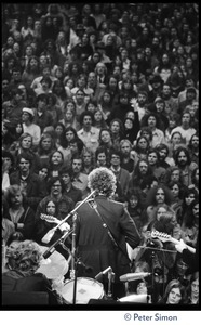 Bob Dylan performing on stage at the Boston Garden with The Band