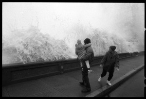 Judy Salonia, her husband Vincent, and daughter Ashley (4) watch as a huge surge crashes against the Narragansett seawall