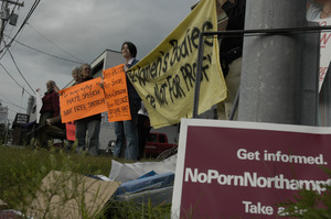 Protest against a pornographic video store in Northampton: protesters with signs reading 'Women's bodies are not for profit' etc.