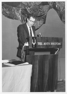 John H. Mitchell at podium in Tel Aviv