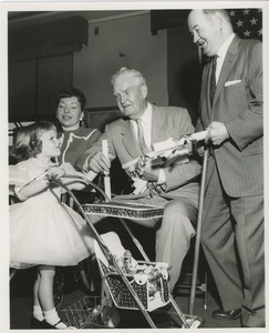 Little girl with stroller and old man with documents