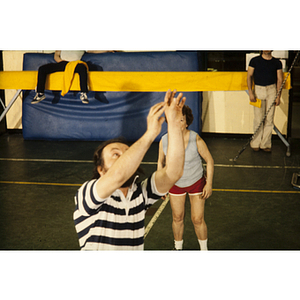 Man reaching his arms up during a game of volleyball