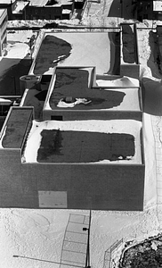 Aerial view of building complex covered in snow