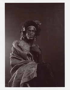 A Portrait of Marsha P. Johnson Wearing a Silky Dress and Tights with Crescent Moons on Them