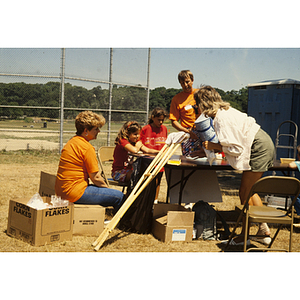 Adults and children seated at a table outdoors