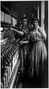 Two female textile workers at a spinning frame. [03]