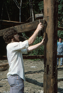 Pegging beam into post at the Moon Barn Raising at entrance to Hopkins Forest on 2 August 1975.