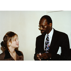 Thomas "Satch" Sanders speaking with unidentified woman