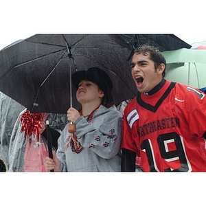 Heidi Buchanan, the Mayor of Huntington Avenue, cheers on the team from beneath her umbrella