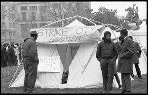 People outside a striker's tent: signs reading 'Strike City Mississippi' and 'Houses not tents,' statue of Lafayette in the background