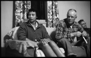 Mildred and Richard Loving seated on a couch with Richard's father (from left)