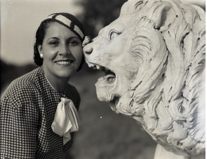Mrs. Carl Miller (?) posed with stone lion