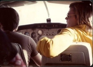 Jim Baker flying in the co-pilot's seat of the commune's Cessna