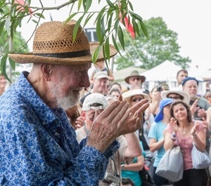 Pete Seeger clasping hands in a river blessing at the Clearwater Festival