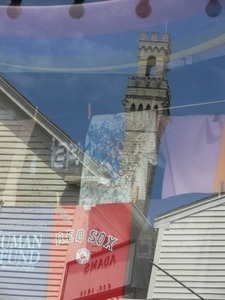 Reflection of the Pilgrim Monument in a store window on Commercial Street, Provincetown